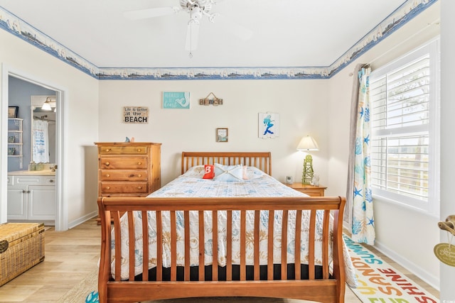 bedroom featuring ceiling fan, connected bathroom, light hardwood / wood-style floors, and multiple windows