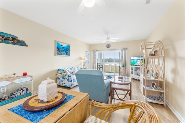 living room featuring ceiling fan and hardwood / wood-style flooring