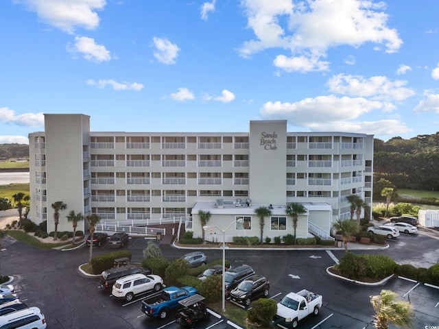 view of building exterior featuring uncovered parking