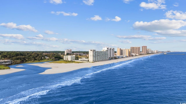 birds eye view of property with a water view, a view of city, and a beach view