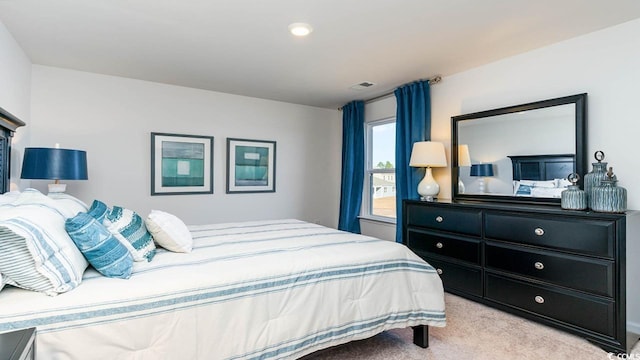 bedroom with light colored carpet