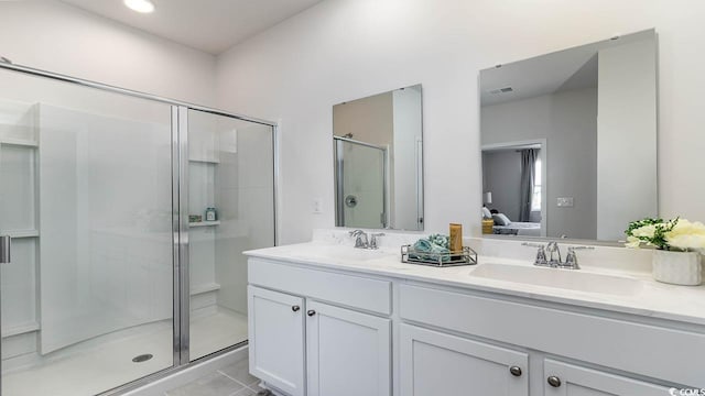 bathroom with tile patterned floors, vanity, and a shower with shower door