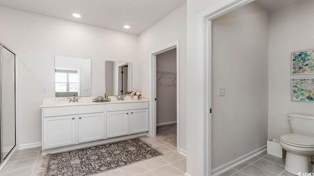 bathroom with vanity, tile patterned floors, and a shower with shower door