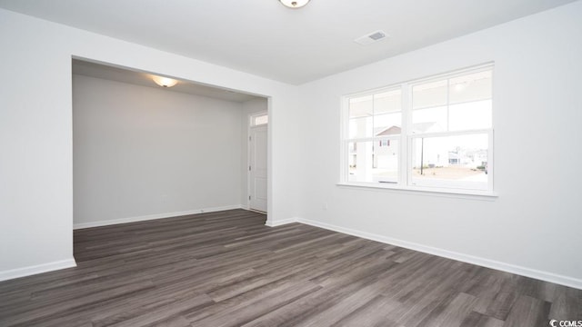 spare room with dark hardwood / wood-style flooring