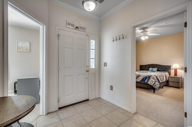 carpeted entrance foyer featuring ceiling fan and ornamental molding