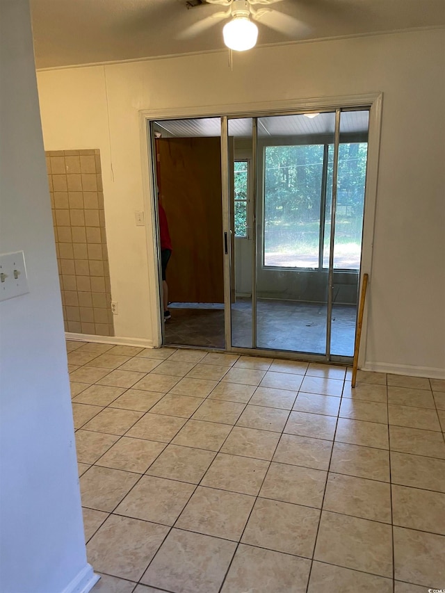 unfurnished room featuring light tile patterned floors and ceiling fan