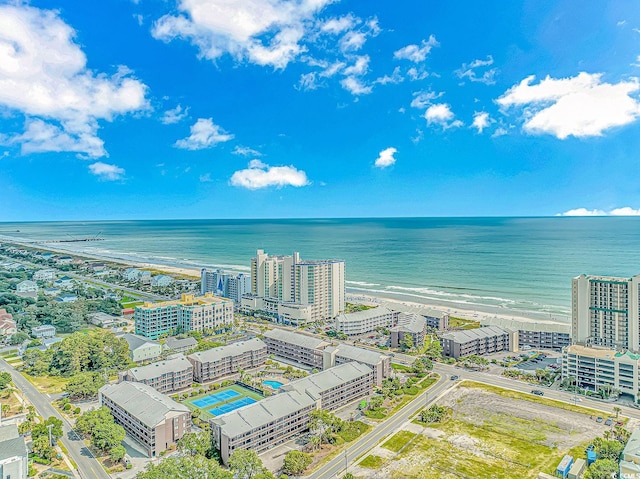 birds eye view of property with a view of the beach and a water view