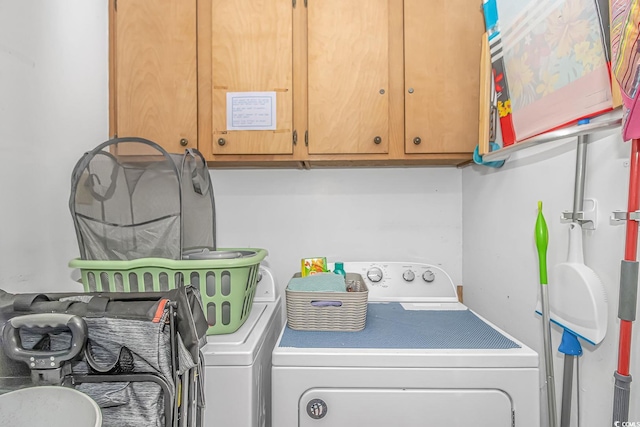 washroom with separate washer and dryer and cabinets