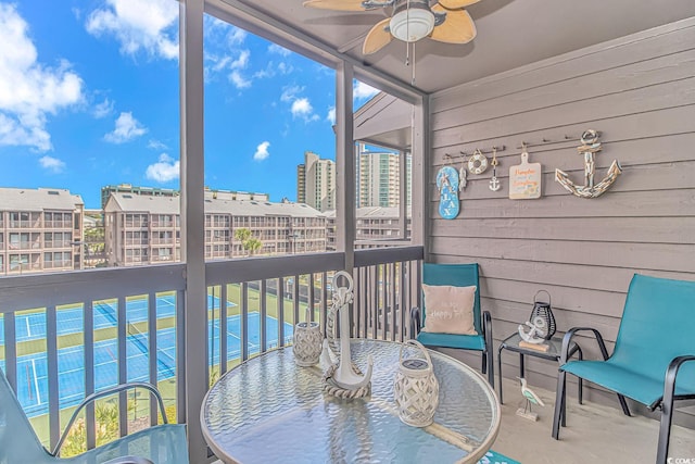 sunroom featuring ceiling fan