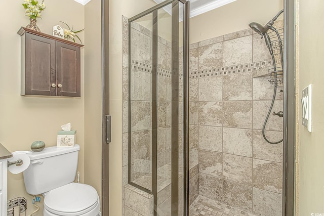 bathroom featuring toilet, crown molding, and walk in shower