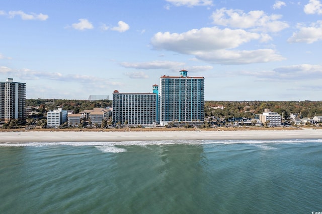 birds eye view of property with a water view and a view of the beach