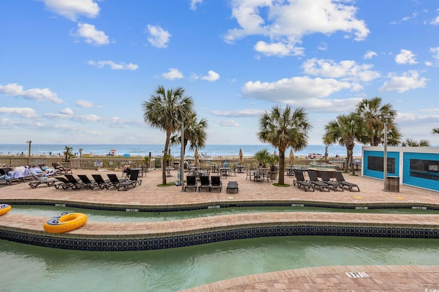 view of swimming pool with a water view