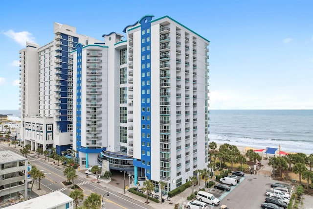 view of property featuring a water view and a view of the beach