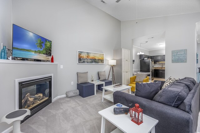 9772 Leyland Dr Unit 9772-9, Myrtle Beach, SC 29572 - living area with high vaulted ceiling, light carpet, a glass covered fireplace, and baseboards
