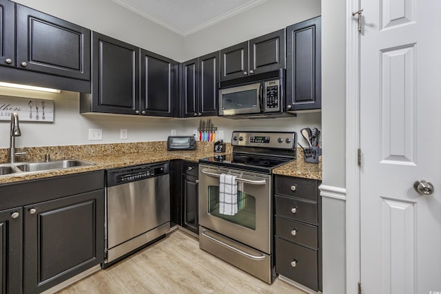 9772 Leyland Dr Unit 9772-9, Myrtle Beach, SC 29572 - kitchen with stainless steel appliances, a sink, ornamental molding, light wood finished floors, and dark cabinets
