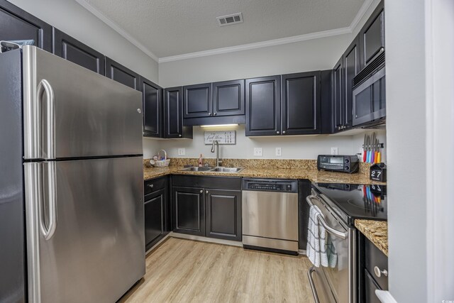 9772 Leyland Dr Unit 9772-9, Myrtle Beach, SC 29572 - kitchen with appliances with stainless steel finishes, a sink, light wood-style flooring, crown molding, and light stone countertops
