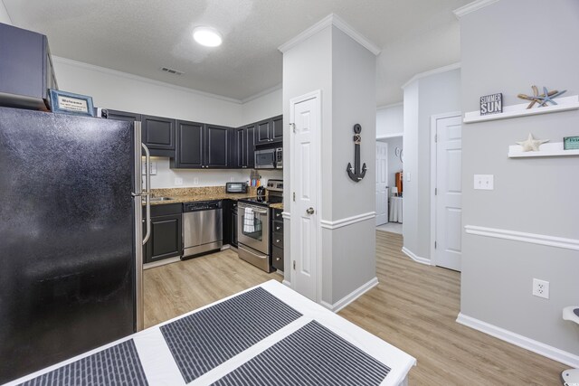 9772 Leyland Dr Unit 9772-9, Myrtle Beach, SC 29572 - kitchen featuring stainless steel appliances, light wood-style flooring, crown molding, baseboards, and dark cabinetry