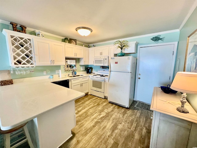 kitchen with crown molding, sink, light hardwood / wood-style floors, white cabinets, and white appliances