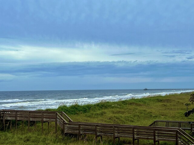 water view with a view of the beach and fence