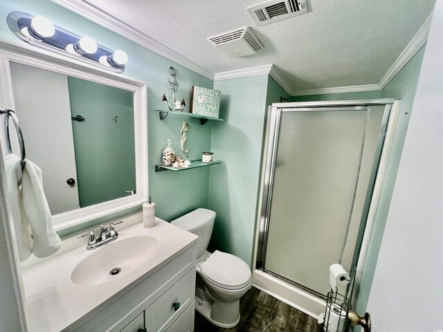 bathroom featuring a stall shower, visible vents, crown molding, and wood finished floors