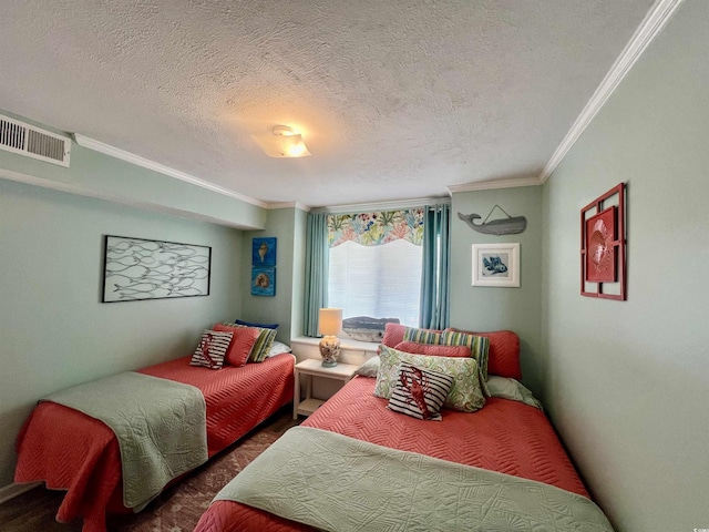 bedroom with crown molding, a textured ceiling, and visible vents