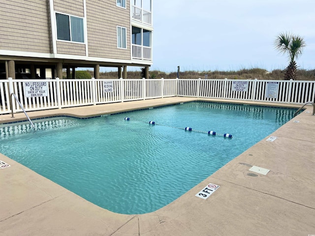 pool with fence and a patio area