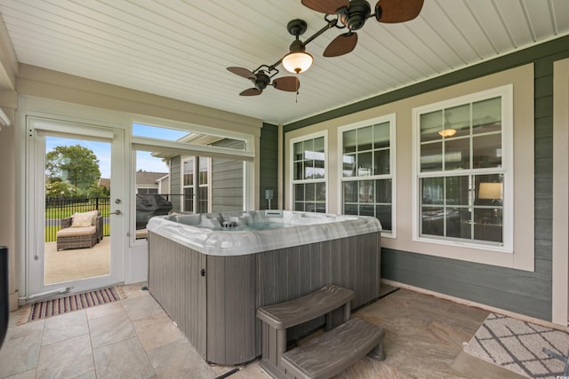 sunroom with a jacuzzi, wood ceiling, and ceiling fan