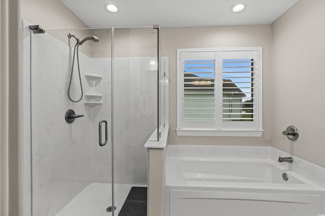 bathroom with separate shower and tub