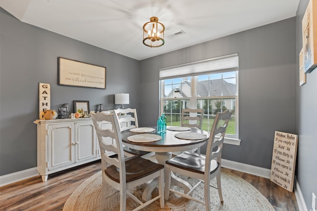 dining space featuring dark wood-type flooring