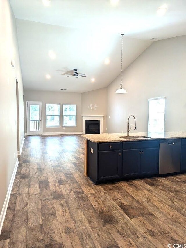 kitchen featuring vaulted ceiling, dark hardwood / wood-style floors, decorative light fixtures, sink, and ceiling fan