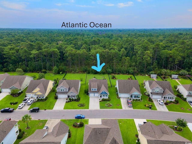 aerial view featuring a forest view and a residential view