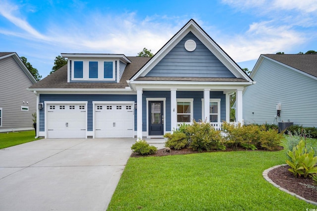 view of front of property with a garage, driveway, central AC unit, covered porch, and a front yard