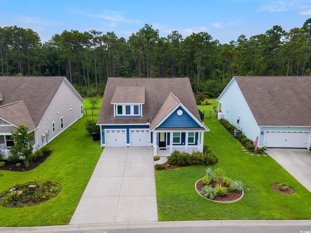 view of front facade with a front yard, concrete driveway, roof with shingles, and central AC