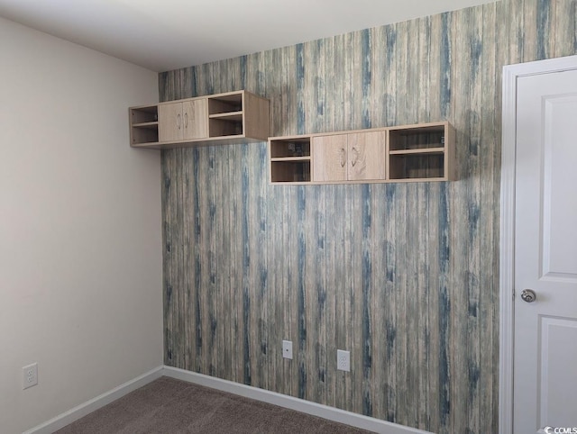 carpeted spare room featuring baseboards