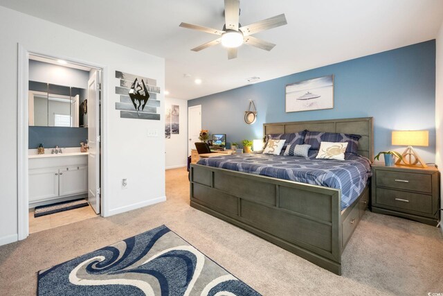 carpeted bedroom with ensuite bathroom and sink