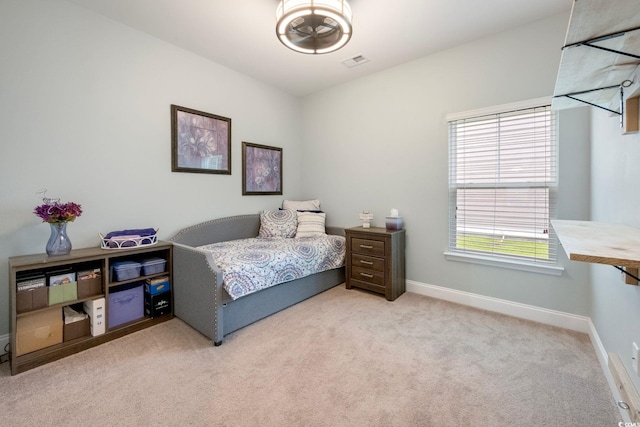 bedroom featuring light carpet, visible vents, and baseboards