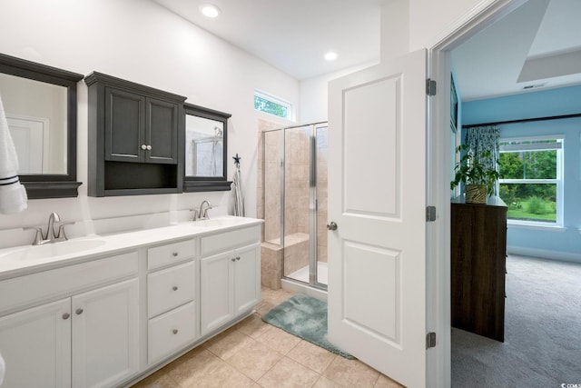 bathroom with vanity, an enclosed shower, and tile patterned floors