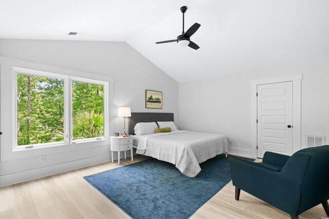 living room featuring ceiling fan, light hardwood / wood-style flooring, and high vaulted ceiling