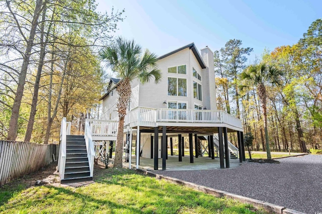 back of house with a patio and a deck