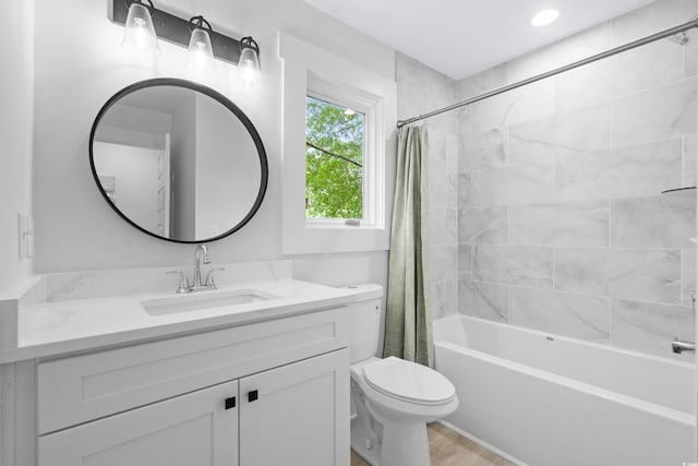 full bathroom with shower / bath combination with curtain, vanity, hardwood / wood-style floors, and toilet