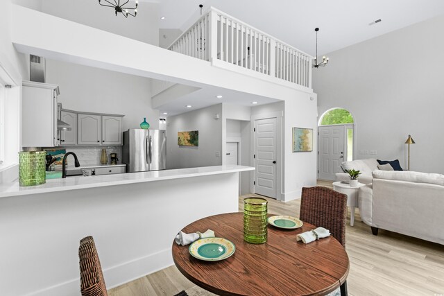 office area with light hardwood / wood-style floors, vaulted ceiling, and ceiling fan