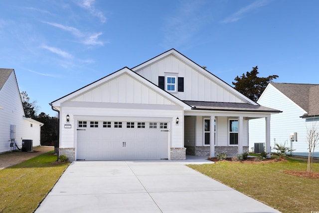 view of front of property with a garage, central AC, a porch, and a front yard