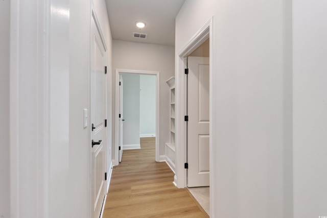 hall with light hardwood / wood-style floors