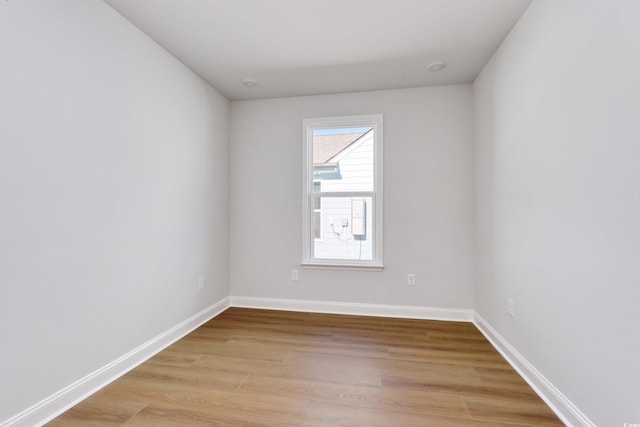 empty room with light hardwood / wood-style flooring