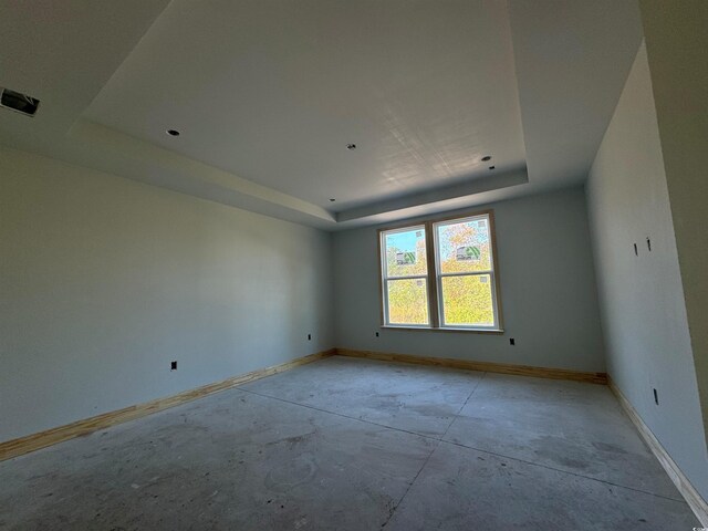 empty room featuring a raised ceiling