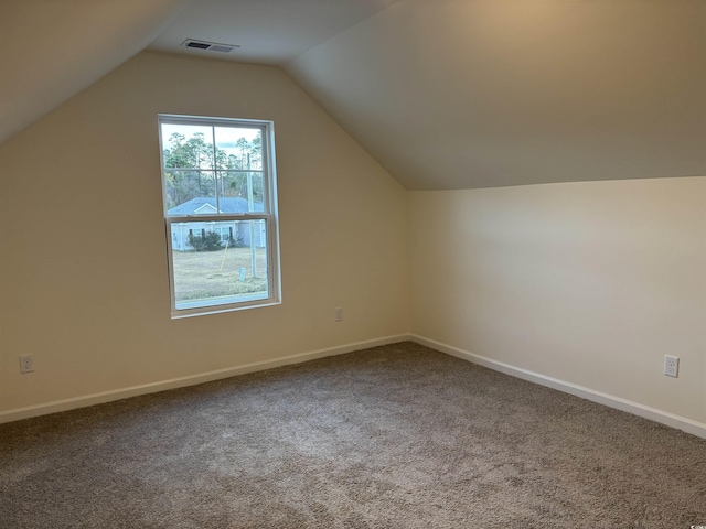 additional living space featuring carpet flooring and lofted ceiling