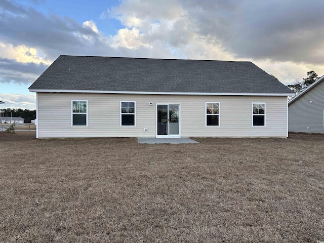 rear view of property featuring a yard