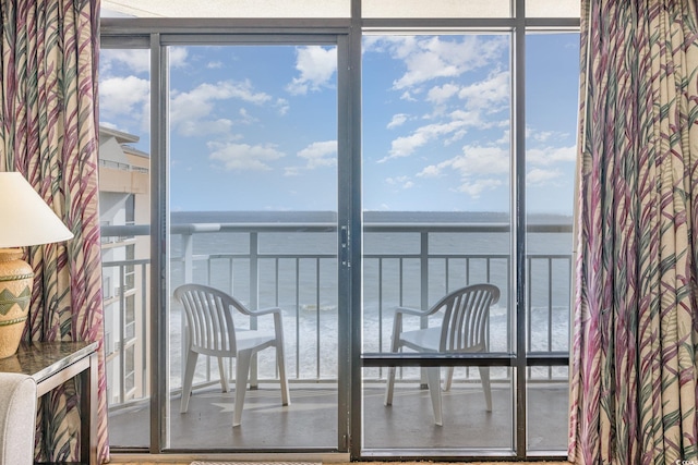 unfurnished sunroom featuring a water view