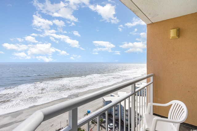 balcony with a water view and a beach view