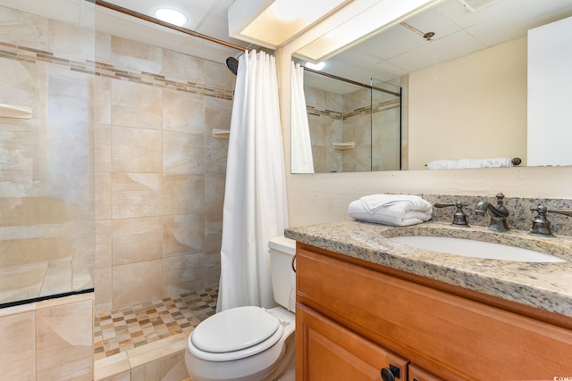 bathroom featuring walk in shower, vanity, and toilet